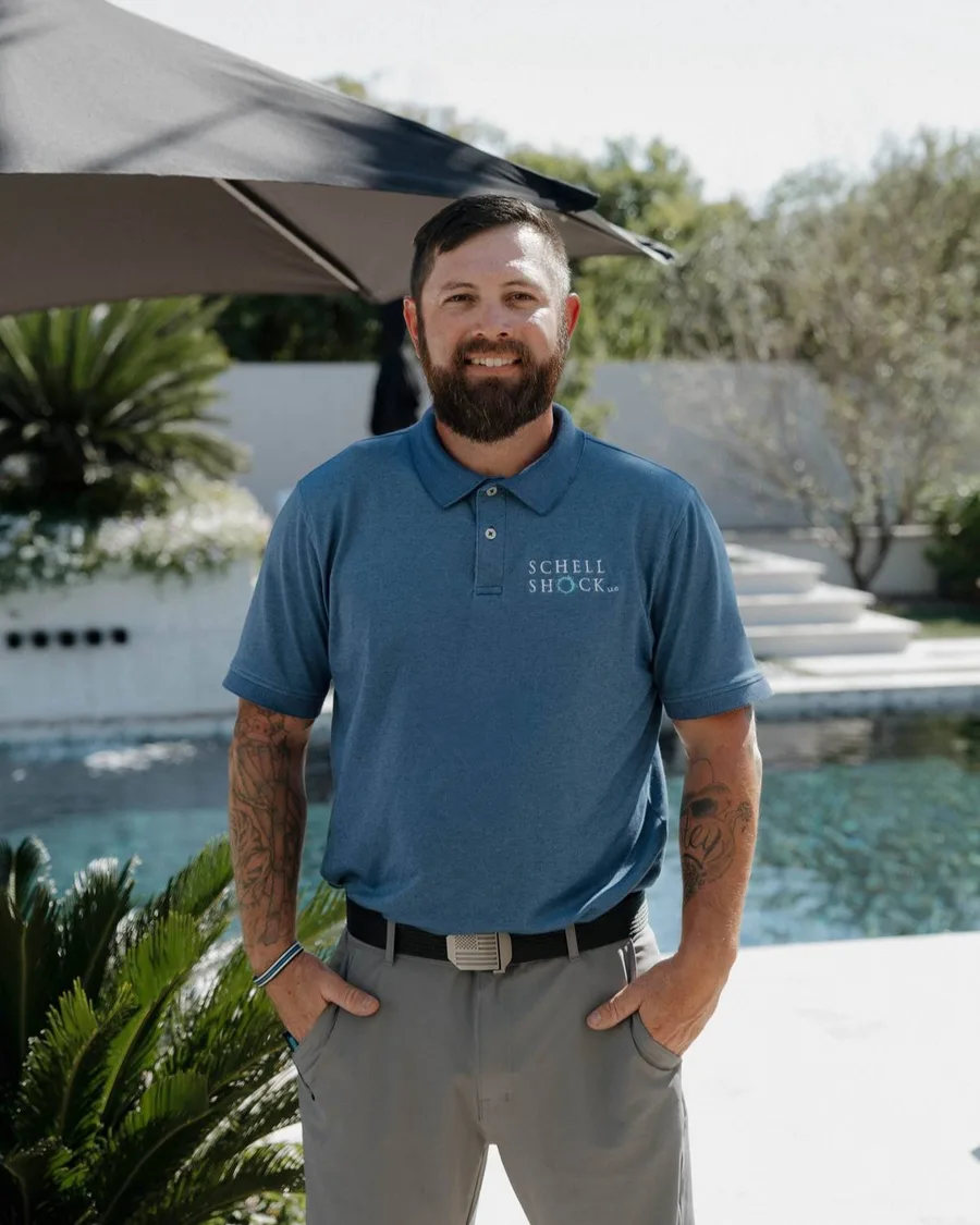 Bryant Schell, owner of Schell Shock LLC, standing by a pool