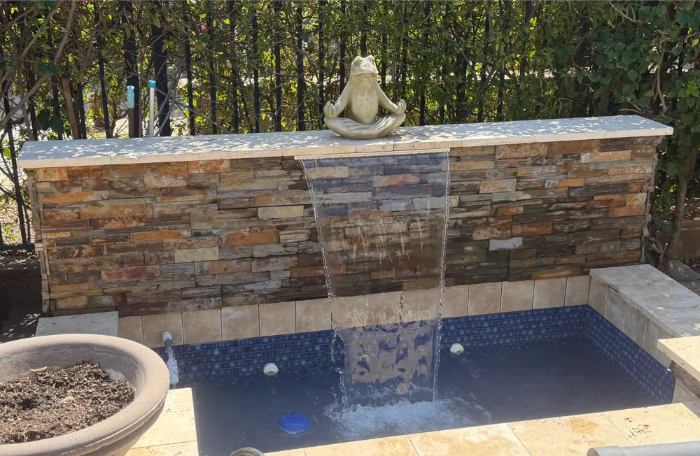 The same water feature flowing with clear blue water after Schell Shock service